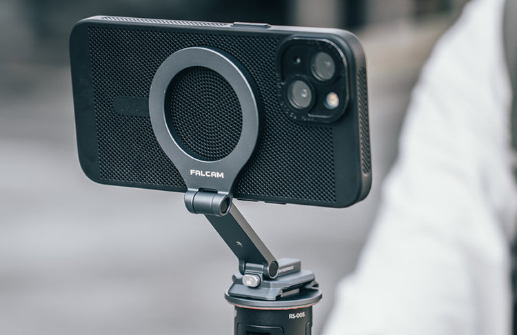 Smartphone held by a Falcam magnetic mount on a tripod for phone photography