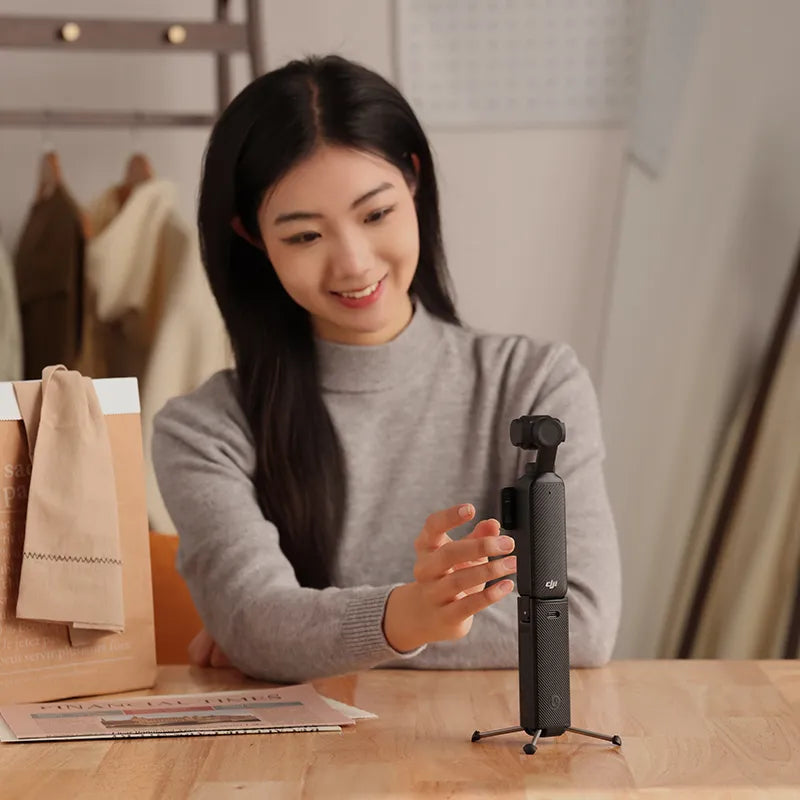 Ulanzi Mini Quadpod Battery Handle for Pocket 3: Creator using handle for content.