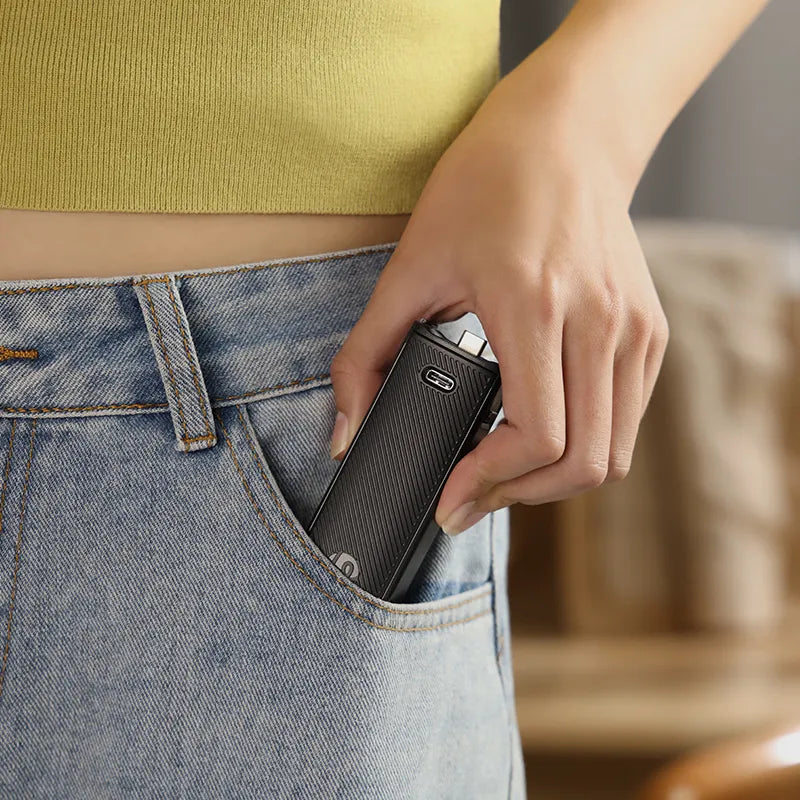 Ulanzi PK-12 Mini Quadpod Battery Handle for Pocket 3, black design, held in pocket.