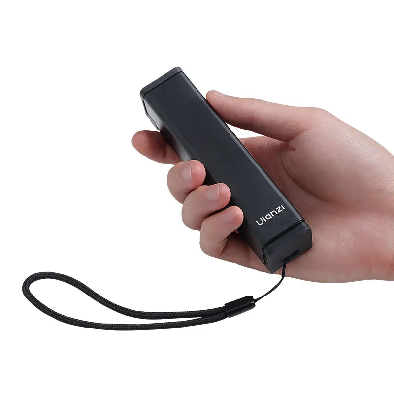 Ulanzi SK-20 Travel Phone Holder M051, black phone holder with strap, held in hand.