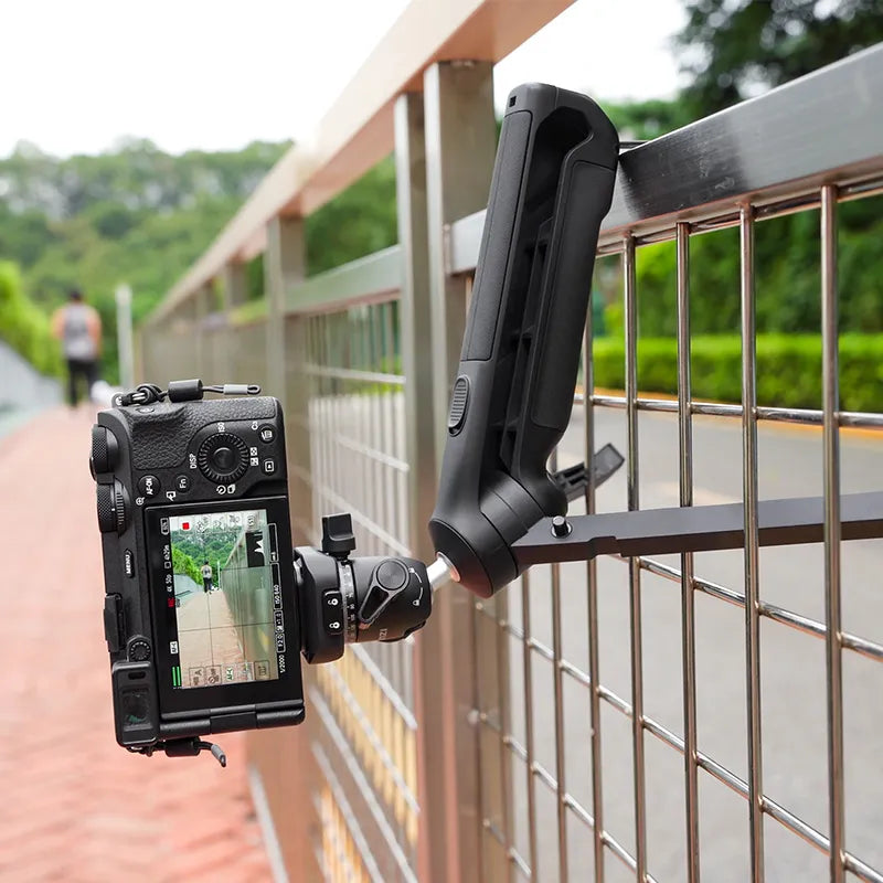 Ulanzi TT38 tripod with camera mounted on a fence, ideal for outdoor vlogging and content creation.