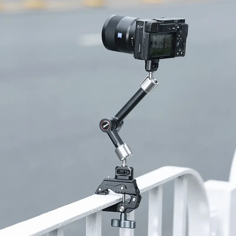 Ulanzi R011a Magic Arm with Crab Clamp holding camera, black metal design, adjustable for filming.