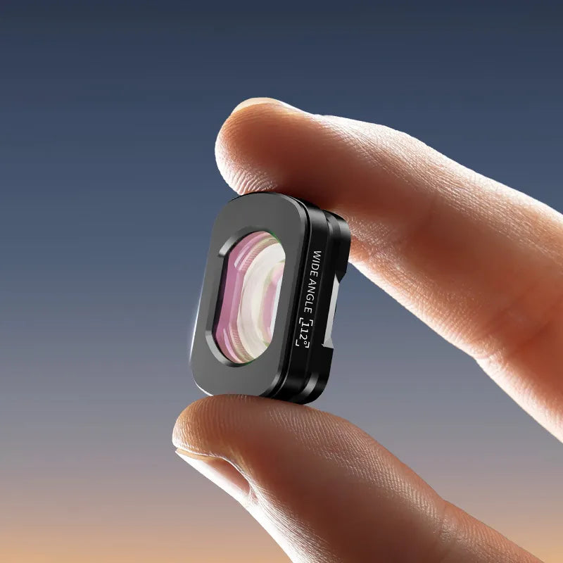 Ulanzi 112° Wide-Angle Lens C051, held between fingers with wide angle text, black finish.