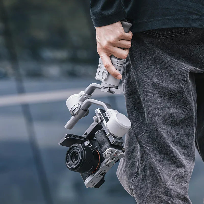 Ulanzi Falcam Quick Release Kit for DJI RS4 Mini holding by a person, gray metal system.