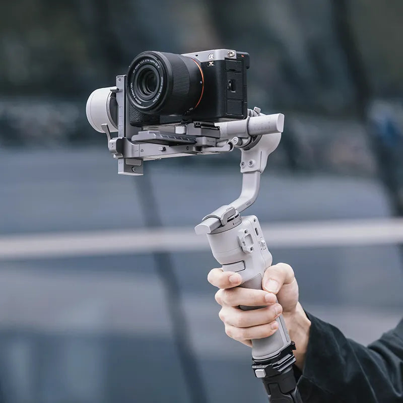 Ulanzi Falcam Quick Release Kit holding a camera. Gray metal and camera stabilizing system.