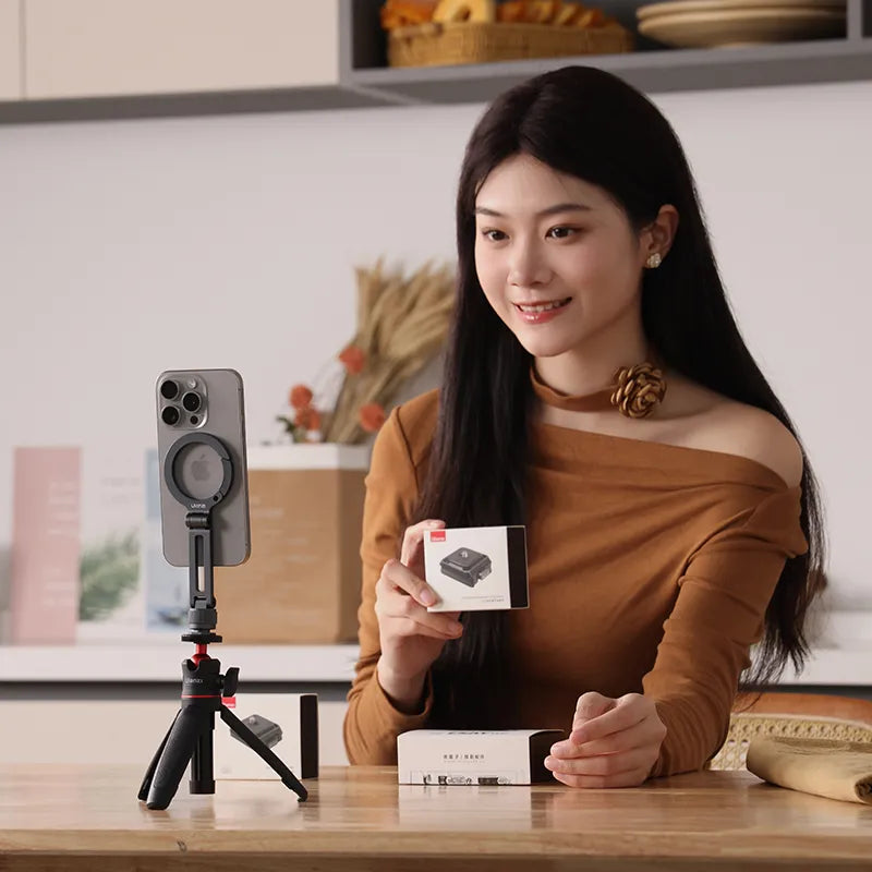 Ulanzi MA07 Maglock phone mount for iPhone with tripod, woman holding product box.