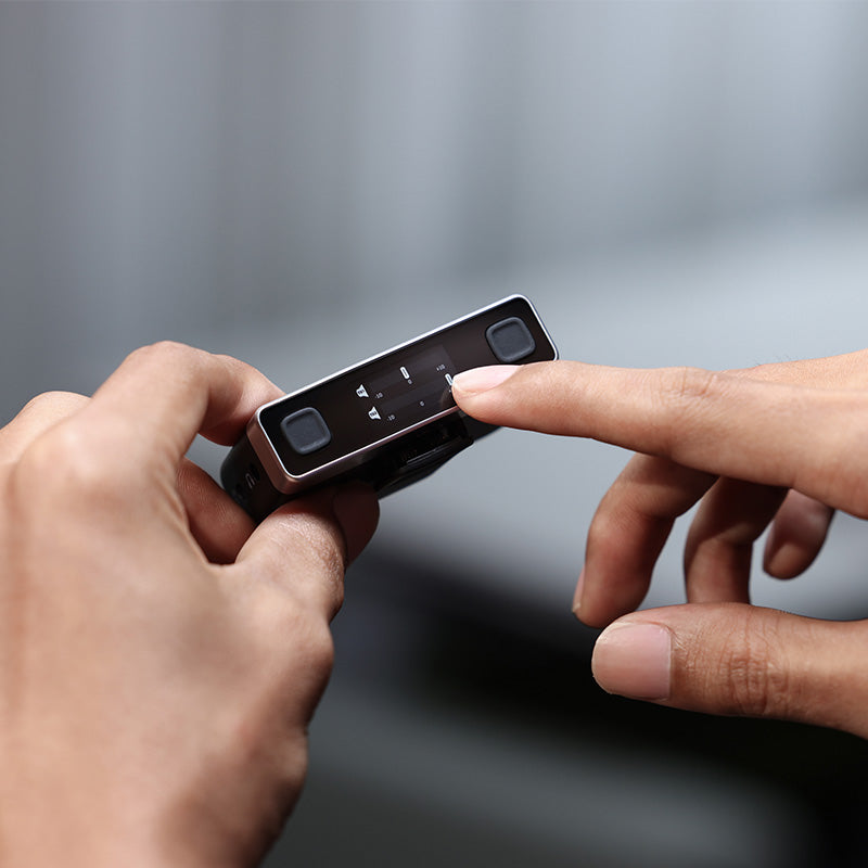 Ulanzi U-Mic AM18 Wireless Microphone receiver adjusting audio levels, black and silver design.