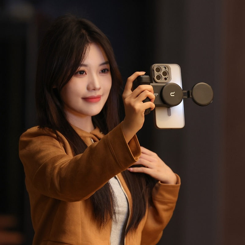 Ulanzi MA35 MagSafe Grip in use, woman taking selfie with iPhone, ergonomic design, black.