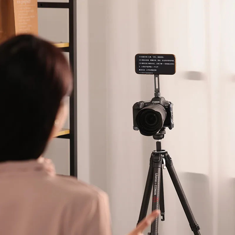 Ulanzi MA07 Phone Mount setup with Canon camera on tripod, featuring text on phone screen.