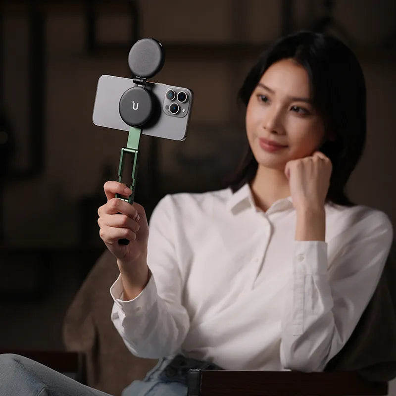 Woman holding phone with Ulanzi MA60 Foldable Magnetic Phone Tripod.