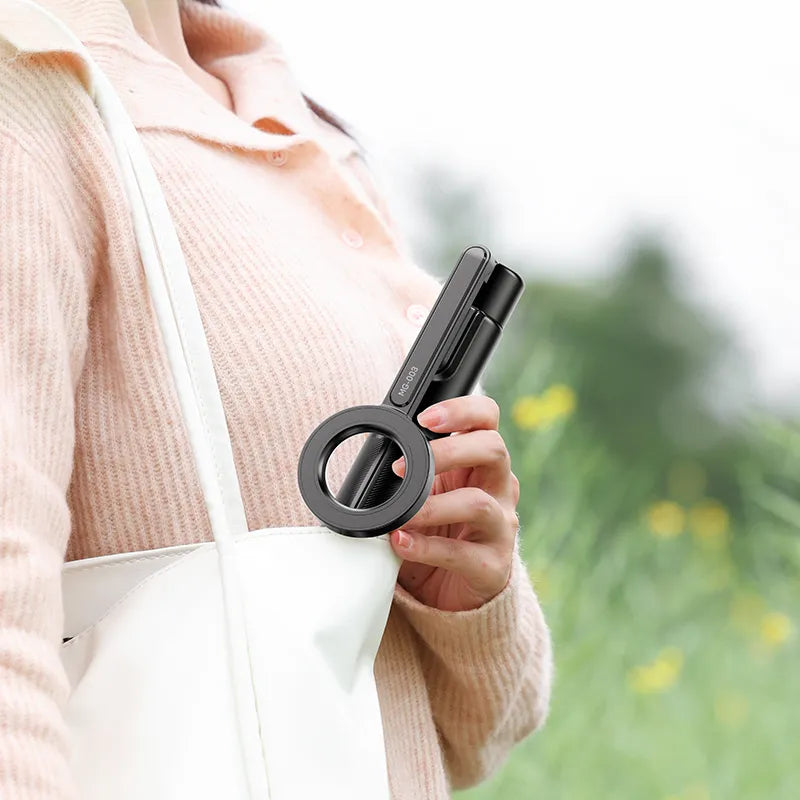 Ulanzi MG-003 Magnetic Phone Selfie Stick Tripod Pro held by a woman outdoors, portable design.