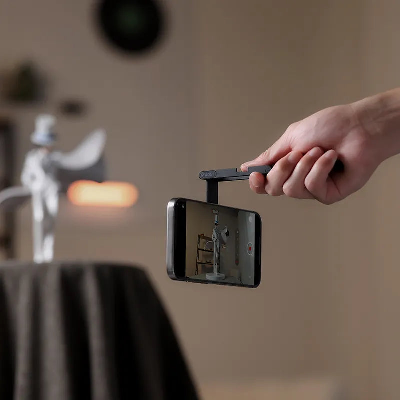 Hand holding phone with Ulanzi MA60 Foldable Magnetic Phone Tripod.