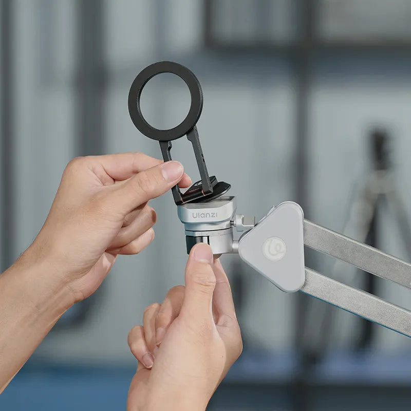 Ulanzi MA50 Uka Magnetic Phone Holder M039, black ring and silver body, user interacting.