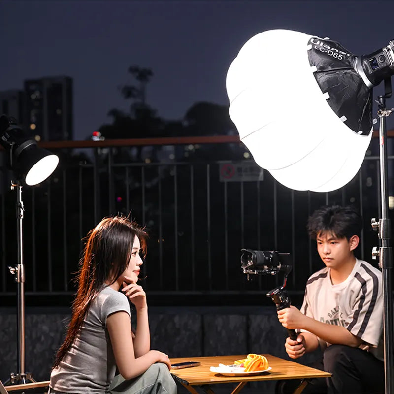 Ulanzi 120W Bi-color RGB video light setup outdoors, filming a woman with soft lighting.