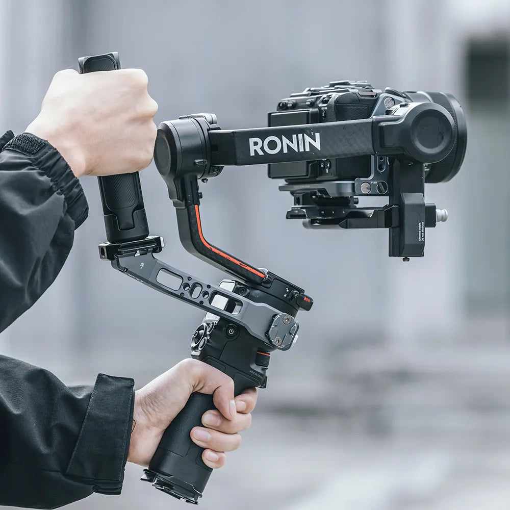 Black Ronin camera stabilizer in use, supporting a camera, perfect for photography and videography.