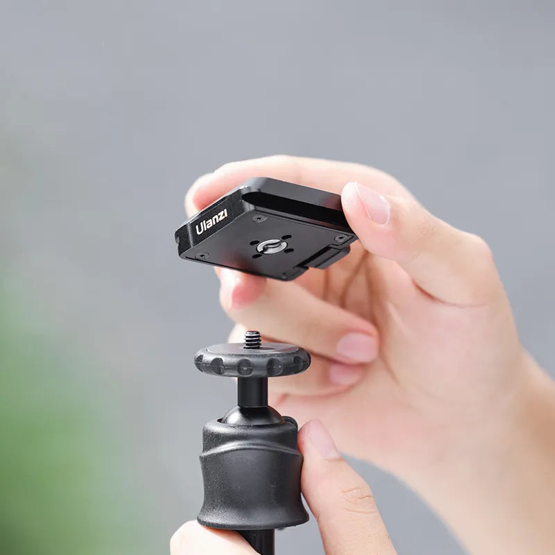 Ulanzi Uka Quick Release Plate C007 being attached to tripod, demonstrating quick release system.