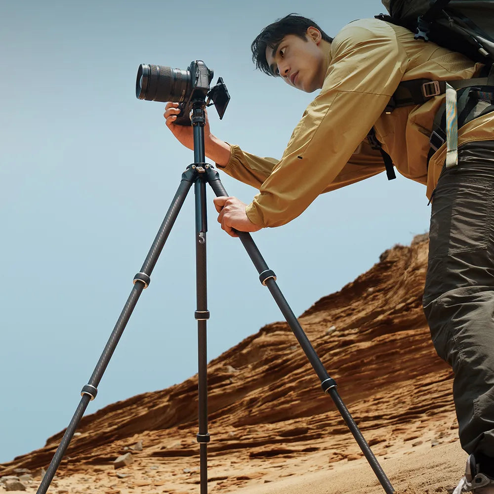Man using Ulanzi Falcam TreeRoot travel tripod in the mountains.