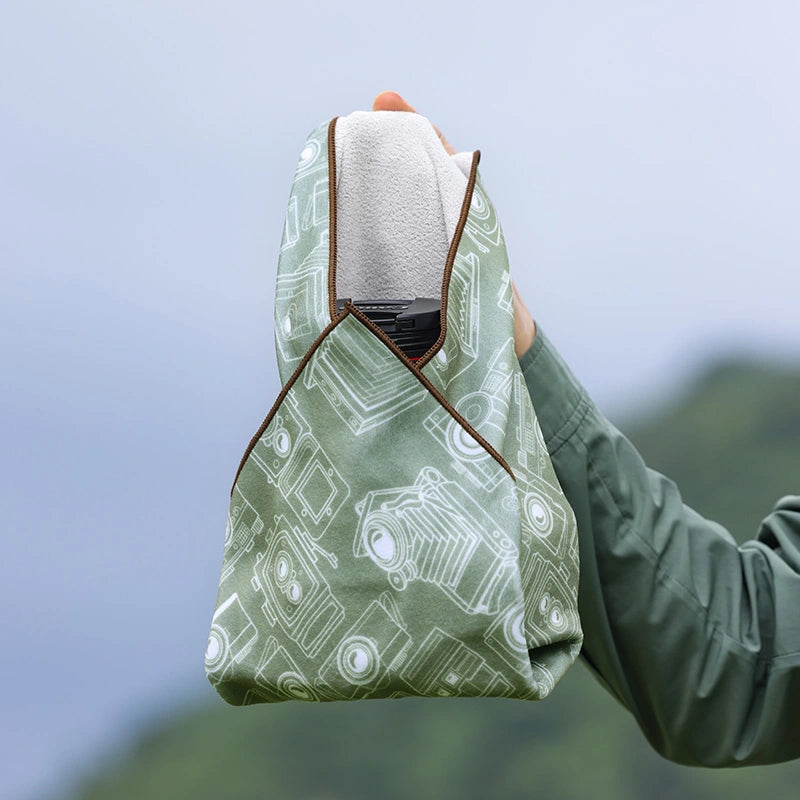 Ulanzi 17-Inch Protective Wrap protecting a camera, green with camera pattern, camera lens protector.