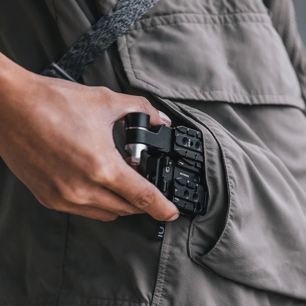 Falcam quick release system F22/F38/F50 series, black, held in pocket.