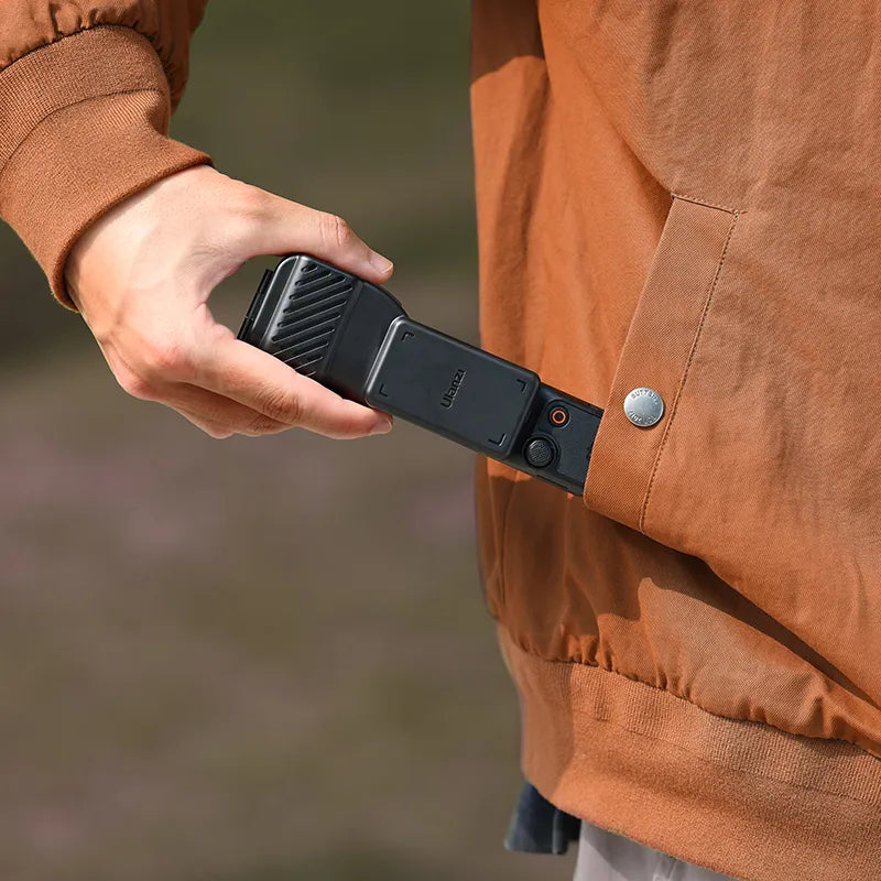 Ulanzi PK-07 Gimbal for DJI Osmo Pocket 3 in use, black gimbal being taken from pocket, Ulanzi logo.