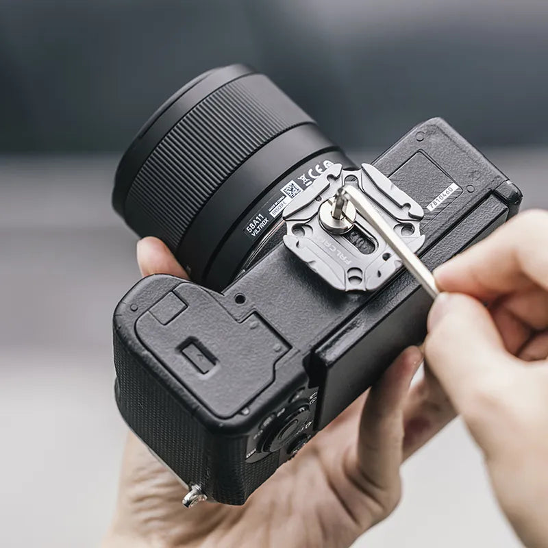 Ulanzi Falcam Quick Release System being installed on a camera, metal gray and black.
