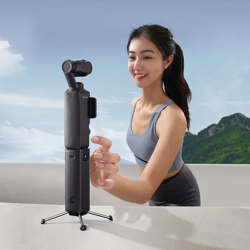 Ulanzi PK-12 Mini Quadpod Battery Handle for Pocket 3 held by a woman outdoors, capturing content.