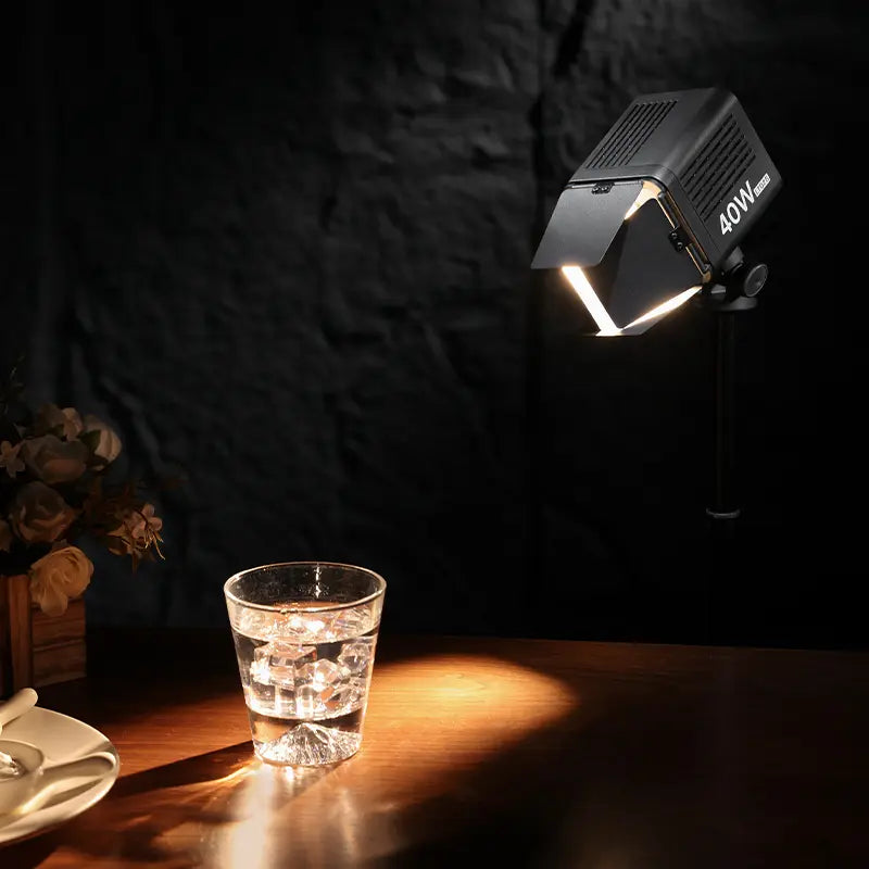 Ulanzi 40W Video Light illuminating glass of water, precise light control for photography.