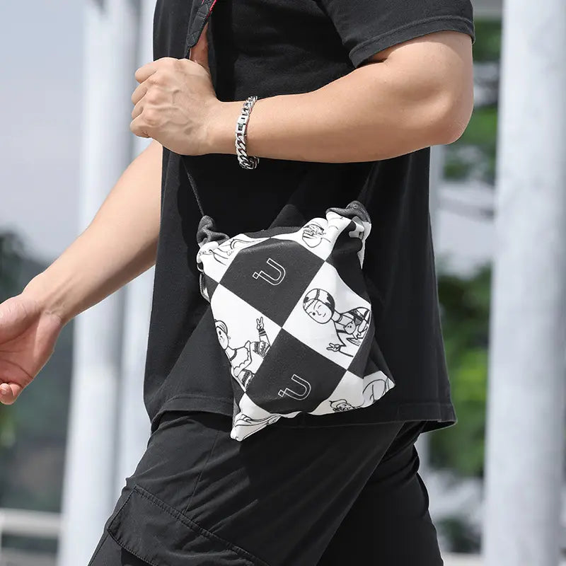 Man wearing black clothes with the Ulanzi checkered pattern bag for camera accessories.