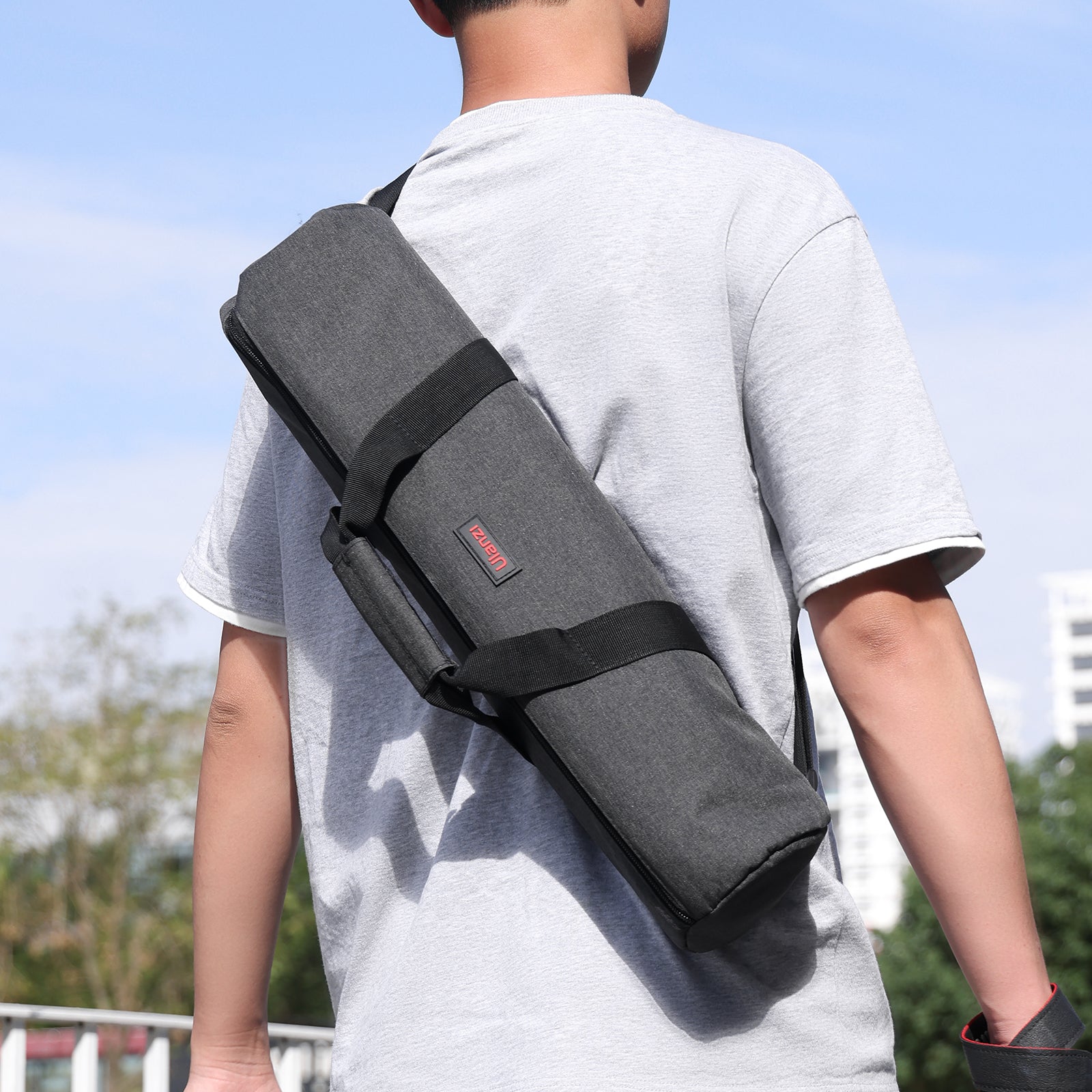 Ulanzi MT-59 tripod bag, dark gray with black straps, carried over the shoulder.