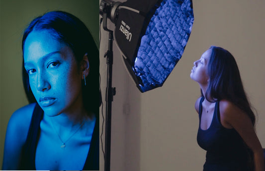 Behind-the-scenes studio photography setup showing dramatic blue lighting effect on model, featuring professional softbox lighting equipment in use