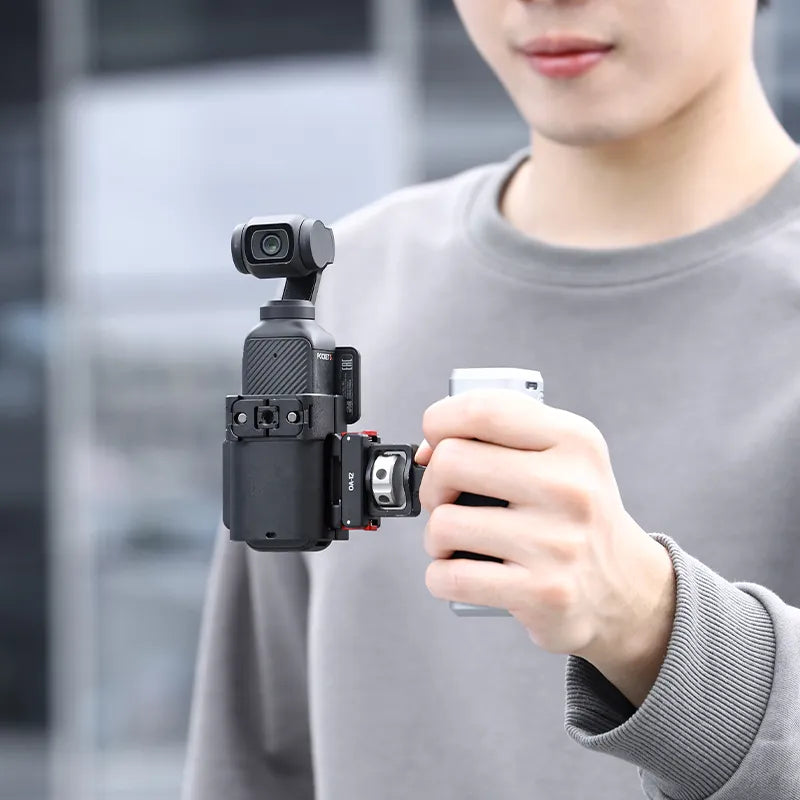 User holding Ulanzi PK-06 adapter with DJI Osmo Pocket 3, showcasing its compact design.