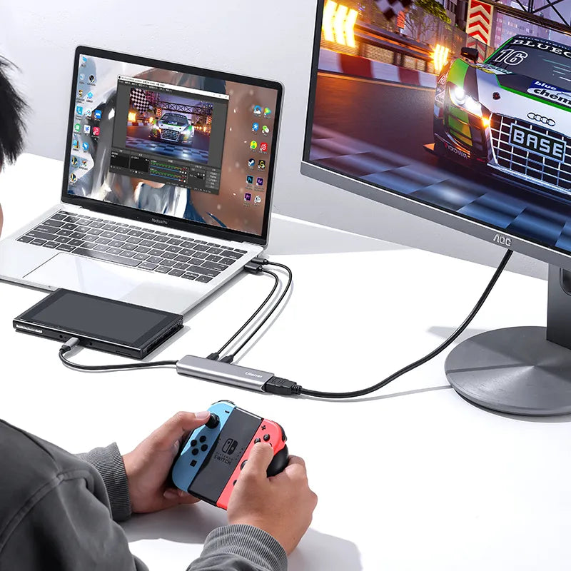 User playing Nintendo Switch with Ulanzi C060 video capture card connecting to laptop