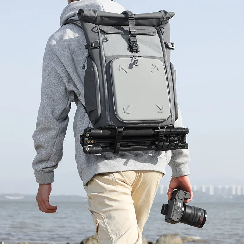 Compact TT53 tripod neatly secured to a photography backpack for on-the-go shooting.