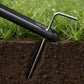 A tripod leg being anchored into the ground with a metal stake.