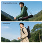 A man walking with a tripod in his backpack.