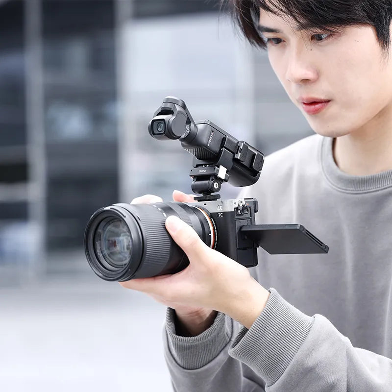 User using Ulanzi PK-06 adapter with DJI Osmo Pocket 3, showcasing versatility.