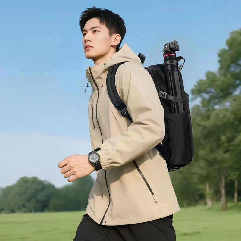 A man walking with a tripod in his backpack.