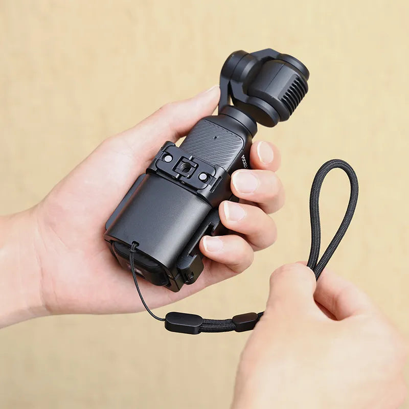 User holds Ulanzi PK-06 adapter with DJI Osmo Pocket 3, highlighting compact design and strap.