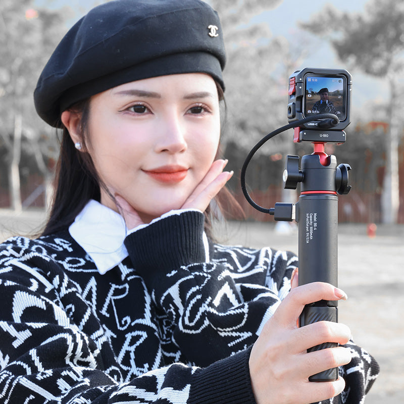 Woman with Ulanzi U-180 Magnetic Ball Head for DJI Action camera, black and red tripod.
