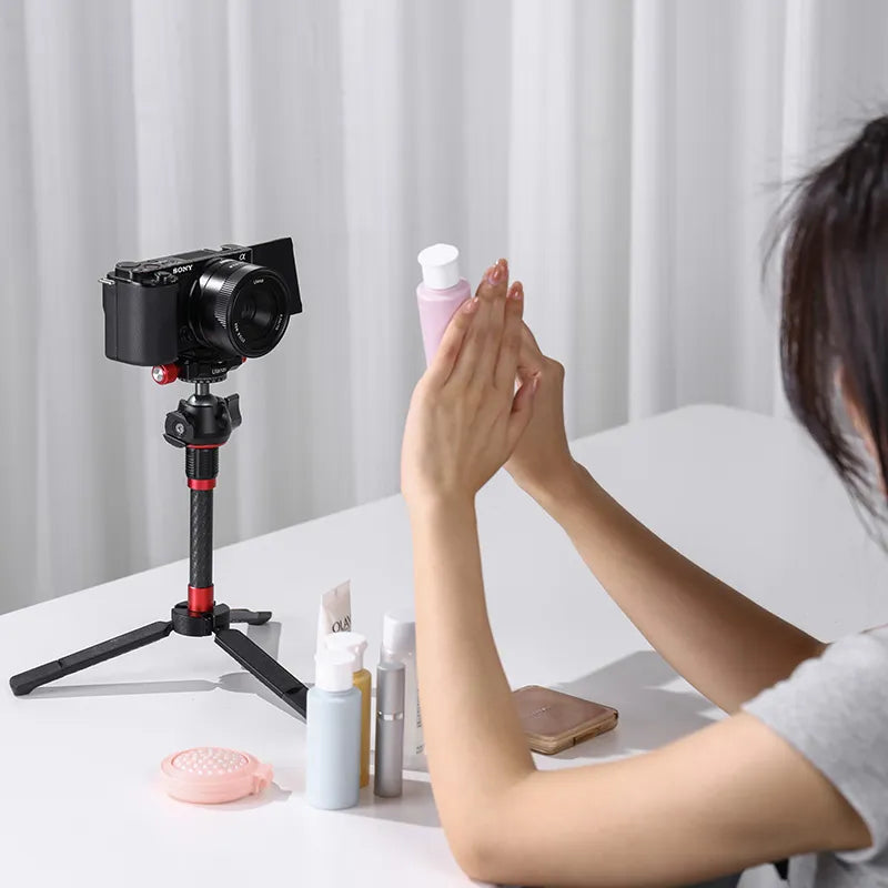 User demonstrating Ulanzi CL02 lens on camera while holding skincare products