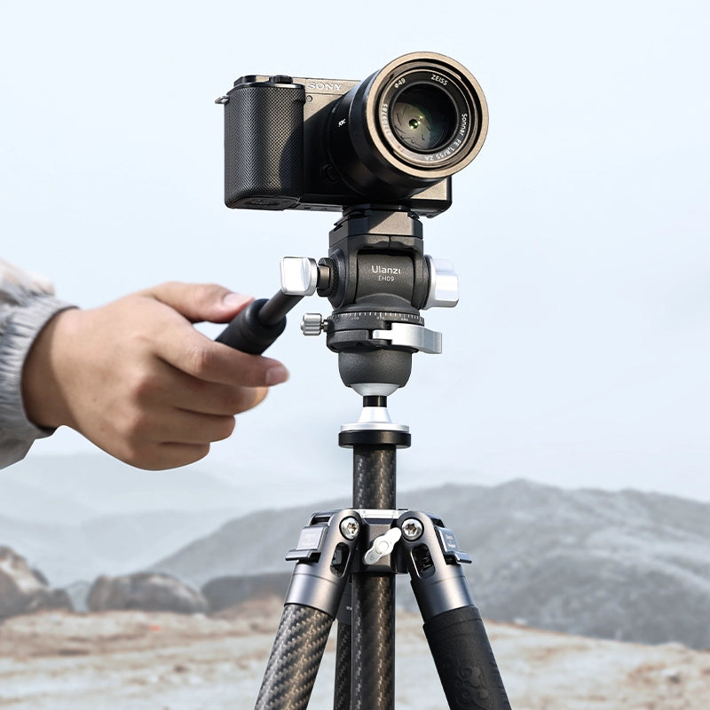 Ulanzi EH09 tripod head with camera in hand, showcasing adjustable features outdoors