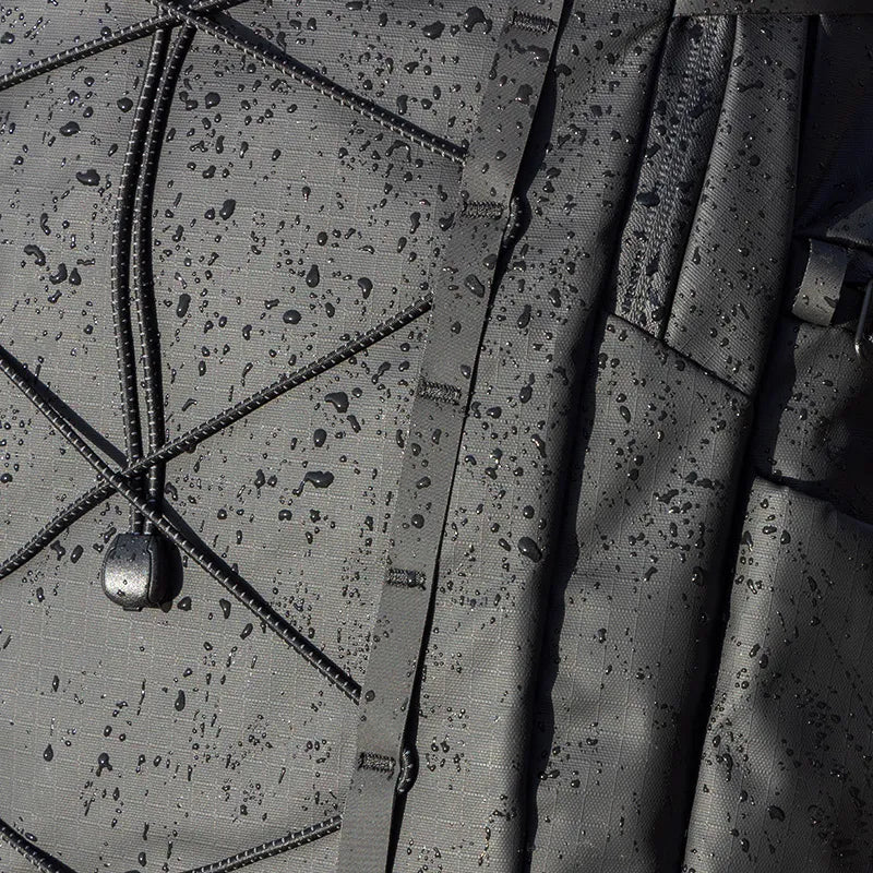 Water-resistant Ulanzi backpack with raindrops and bungee cord design.