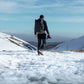 Photographer exploring snowy mountain terrain with Ulanzi camera backpack.