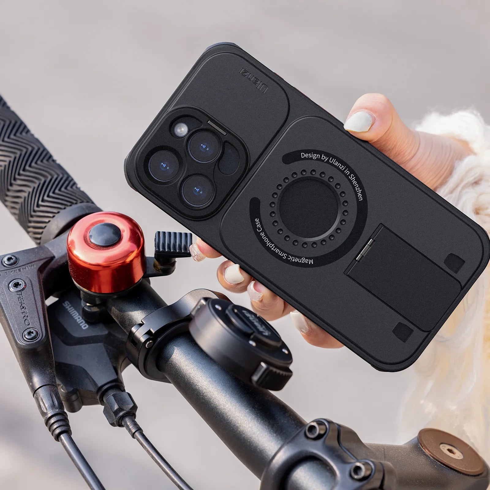 Ulanzi O-LOCK Phone Video Kit with magnetic grip mounted on bicycle handlebar.