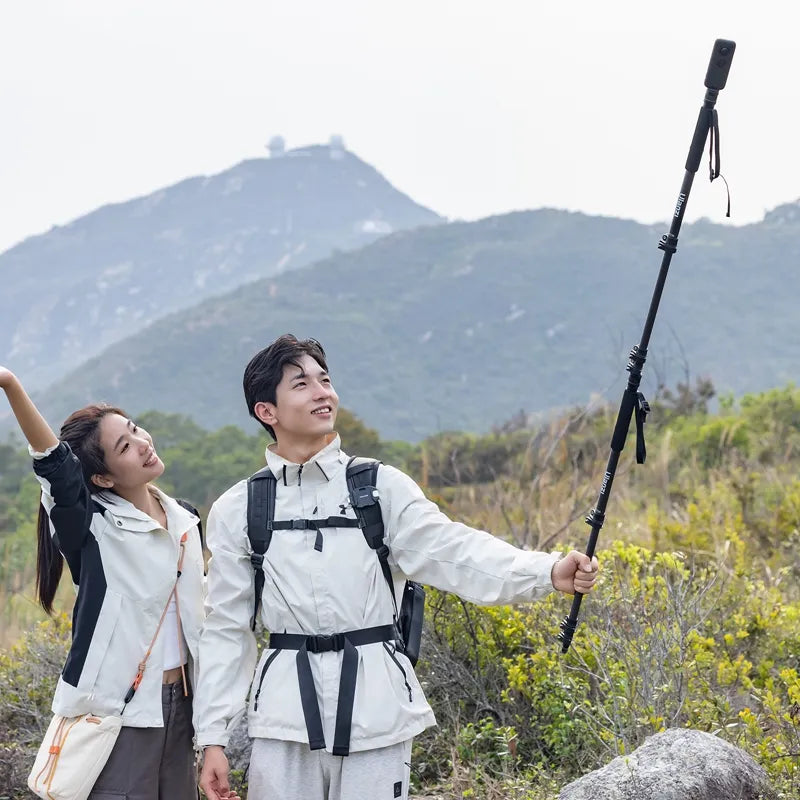 Couple using Ulanzi TT35 Hiking Stick Tripod Kit for selfies on a hiking trail.