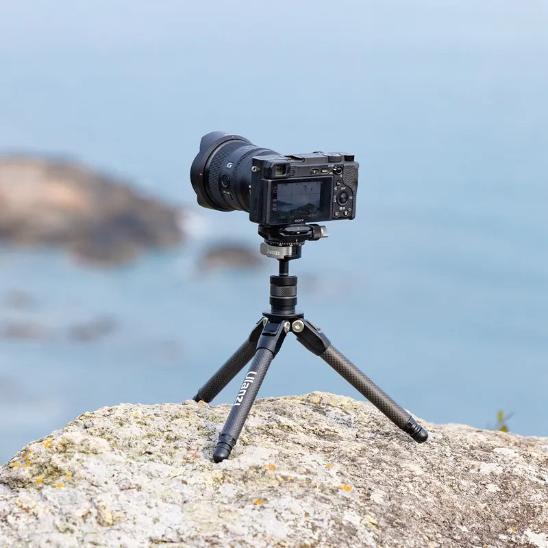 Ulanzi TT35 Tripod Kit holding a camera on rocky coastline for outdoor photography.