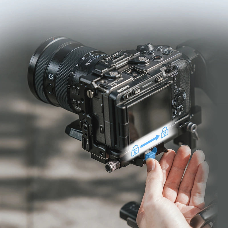 Ulanzi FALCAM F38 Quick Release Base V2 attached to a Sony camera, showing hand engaging locking mechanism