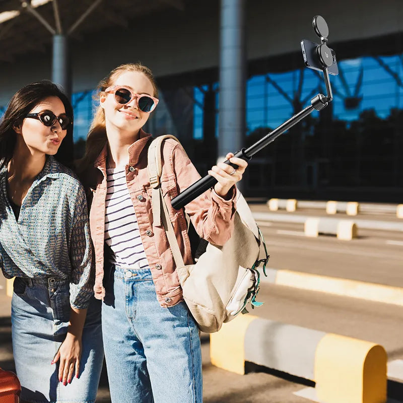 Girls using Ulanzi Magnetic Phone Selfie Stick Tripod for outdoor selfies.