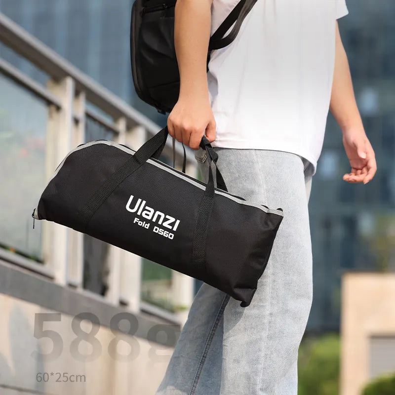 Person holding Ulanzi Fold softbox bag for portable photography lighting