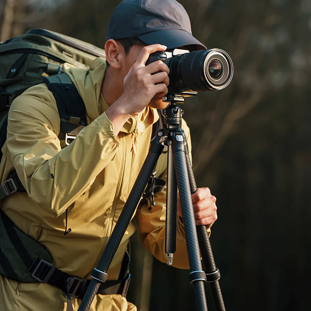 Photographer using TreeRoot Quick Lock Lite Tripod outdoors.